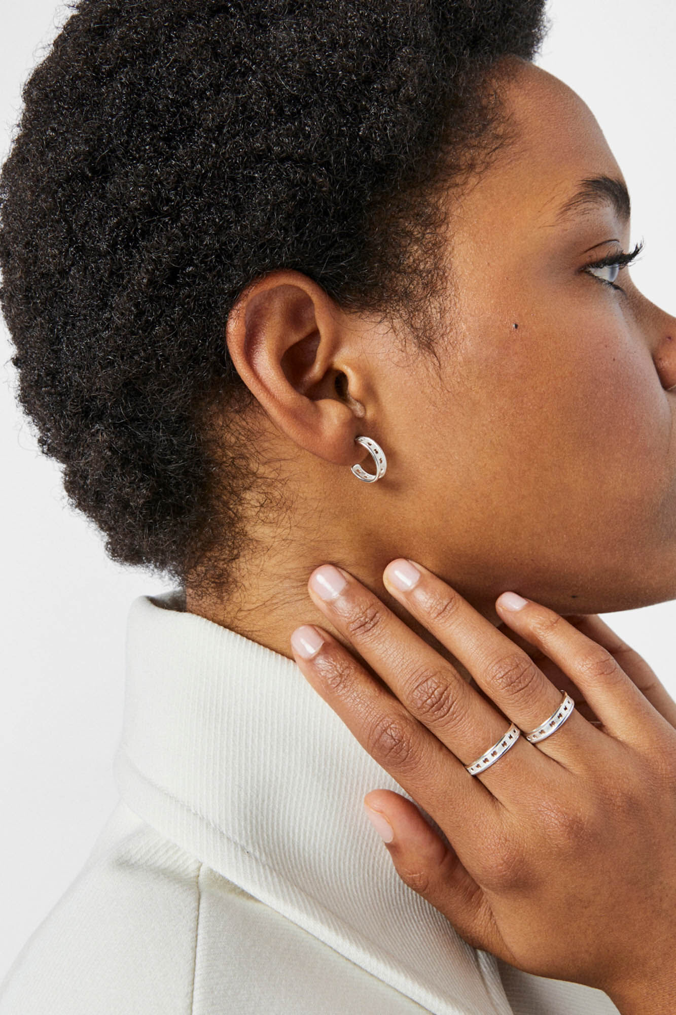 Small silver hoop earrings with a TOUS Bear Row silhouette